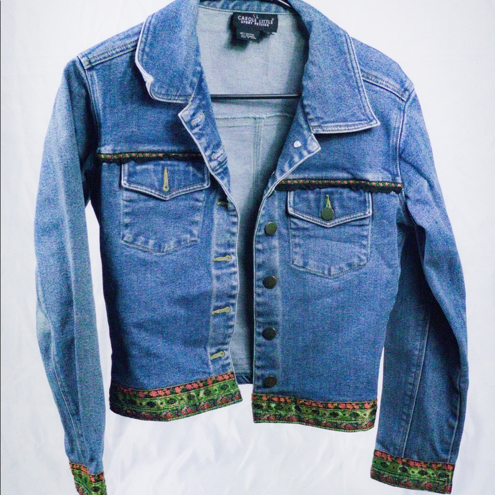 Small jean jacket with flower trim.